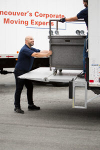 Man pushing cart into moving truck